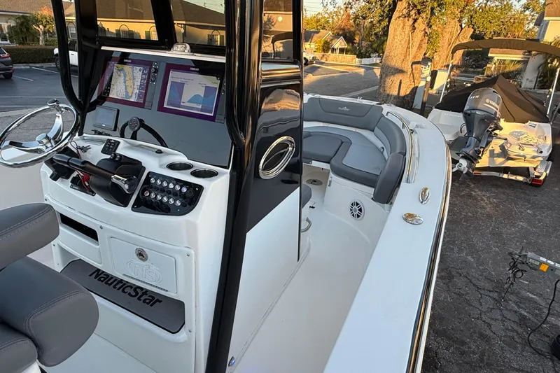 Slide: The Image of 2023 NauticStar 2602 Legacy boat interior with modern dashboard and seating. - 35