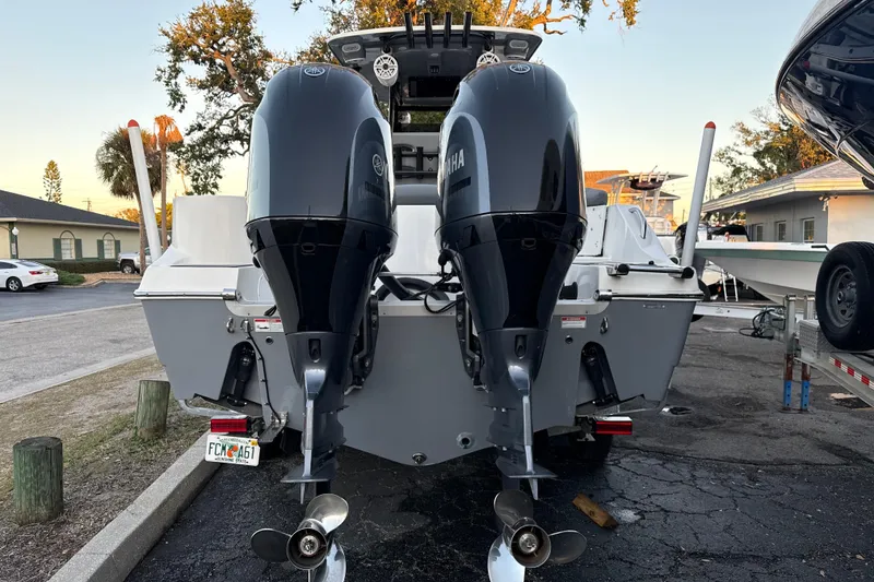 Slide: The Image of 2023 NauticStar 2602 Legacy boat with dual Yamaha outboard engines, parked on a trailer. - 4