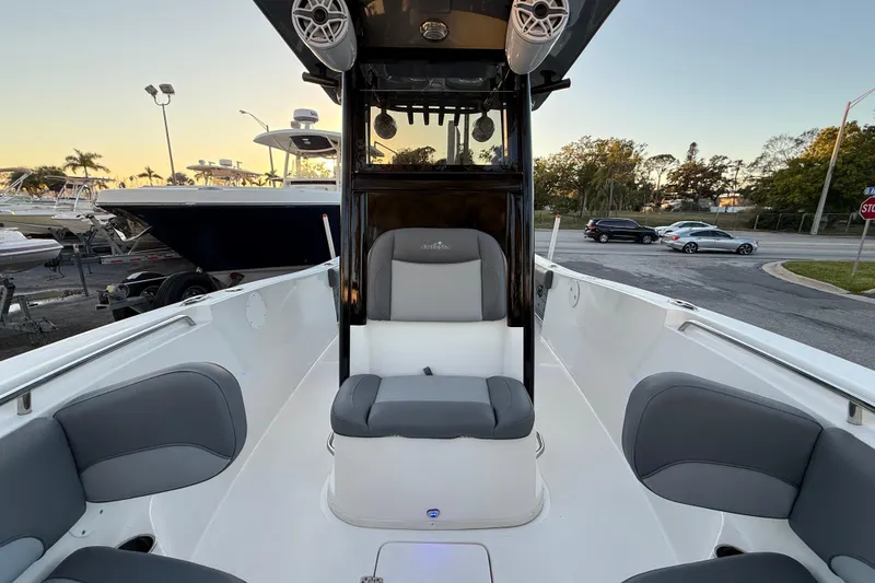 Slide: The Image of 2023 NauticStar 2602 Legacy boat interior with seating and speakers at sunset. - 47