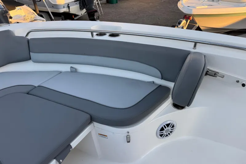 Slide: The Image of 2023 NauticStar 2602 Legacy boat interior with gray cushioned seating and cup holders. - 51