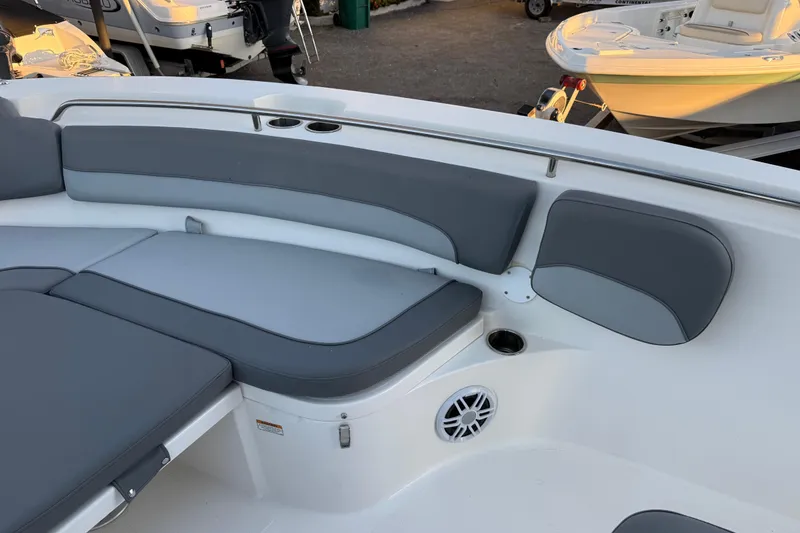 Slide: The Image of 2023 NauticStar 2602 Legacy boat interior with gray cushioned seating and cup holders. - 52
