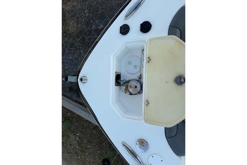 Slide: The Image of 2023 NauticStar 2602 Legacy boat anchor compartment with open hatch. - 54