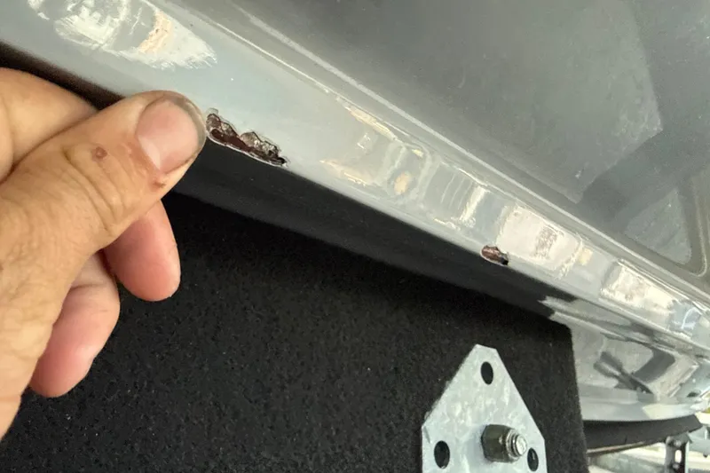 Slide: The Image of Close-up of damage on 2023 NauticStar 2602 Legacy boat hull. - 57