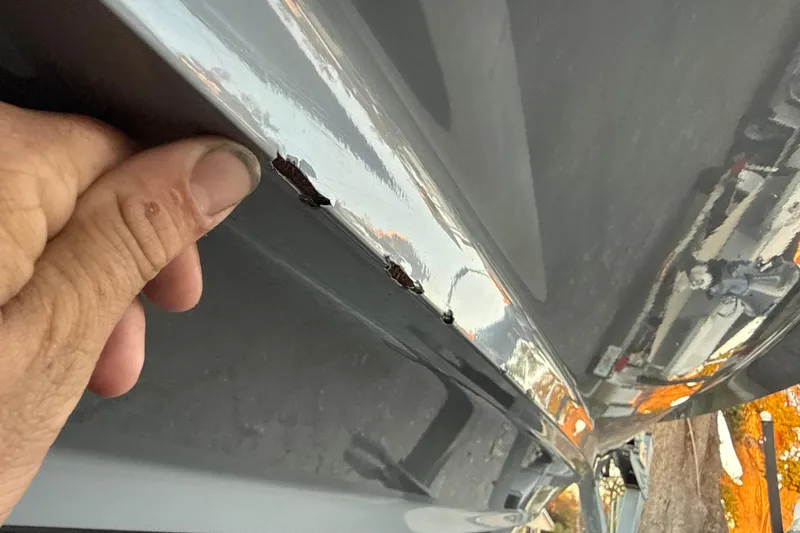 Slide: The Image of Close-up of damage on a 2023 NauticStar 2602 Legacy boat hull. - 59