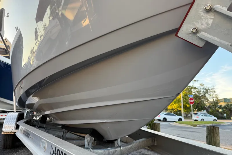 Slide: The Image of 2023 NauticStar 2602 Legacy boat on trailer, close-up view of hull. - 6