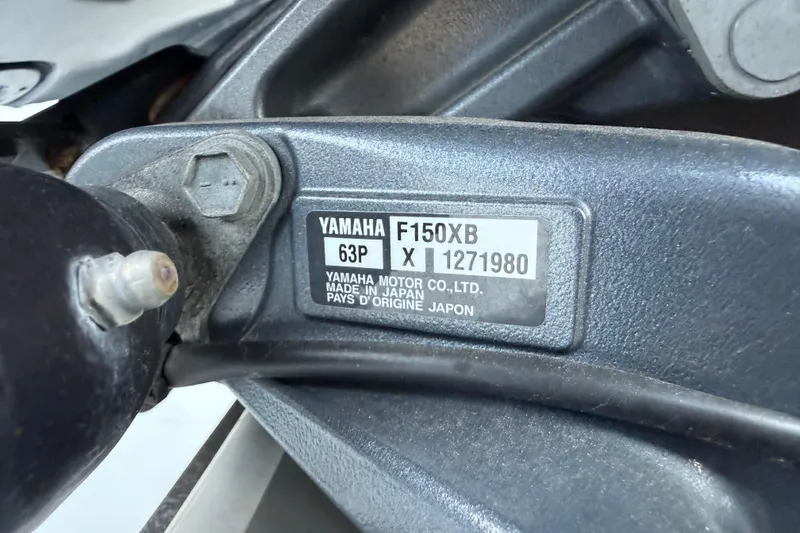 Slide: The Image of Yamaha F150XB engine label on 2023 NauticStar 2602 Legacy boat, close-up view. - 9