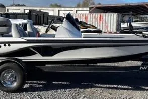 Slide: The Image of 2024 Nitro Z17 boat, sleek design, parked on gravel lot. - 1