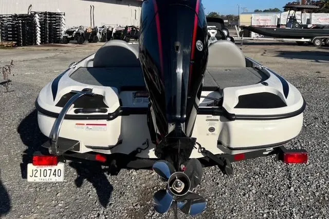 Slide: The Image of 2024 Nitro Z17 boat with powerful outboard motor, parked on gravel lot. - 7