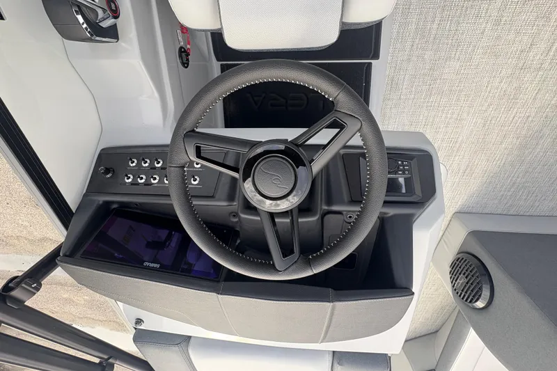 Slide: The Image of Steering wheel and dashboard of 2026 Alera M 25L boat, featuring modern controls. - 13