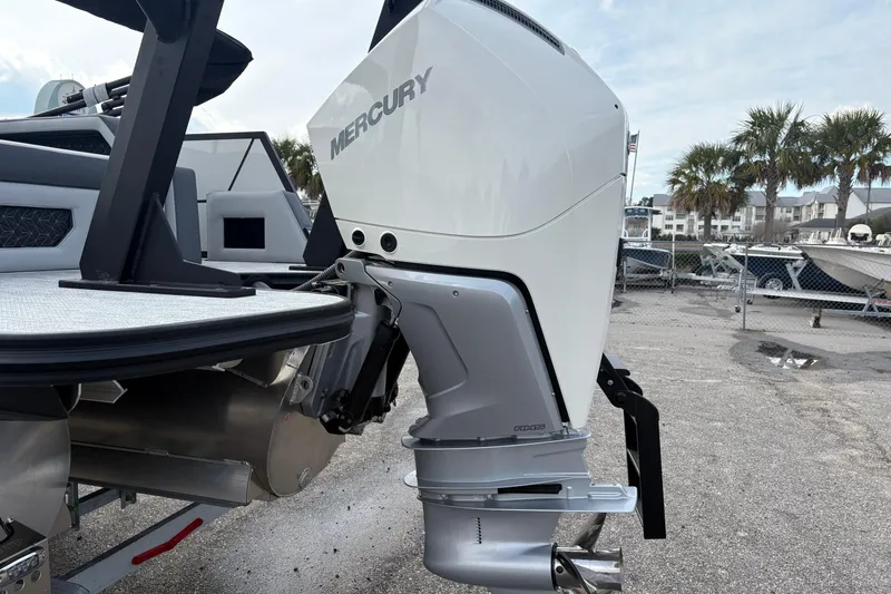 Slide: The Image of Alera M 25L 2026 boat with Mercury outboard engine in marina setting. - 14