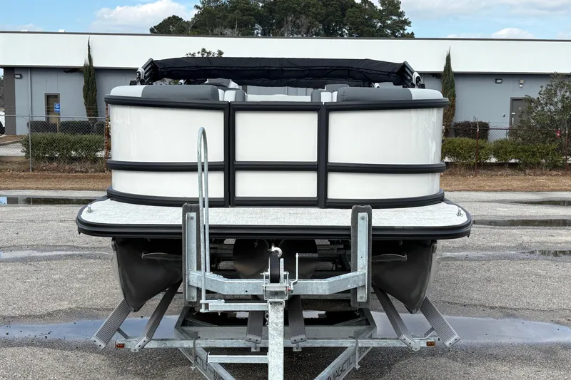 Slide: The Image of 2026 Alera M 25L pontoon boat on trailer, parked outdoors. - 8