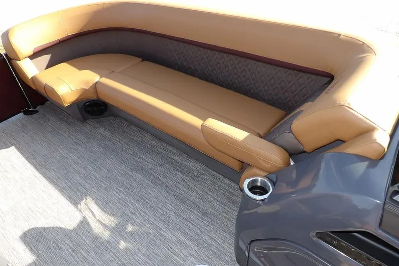 Slide: The Image of 2026 Bennington M L-Bench 22 ML boat interior with tan seating and cup holders. - 13