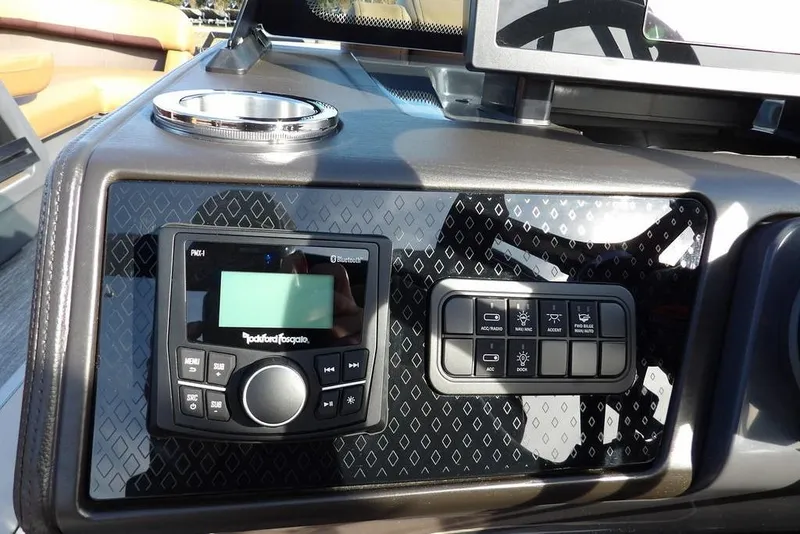 Slide: The Image of Dashboard of 2026 Bennington M L-Bench 22 ML with audio controls and switches. - 25