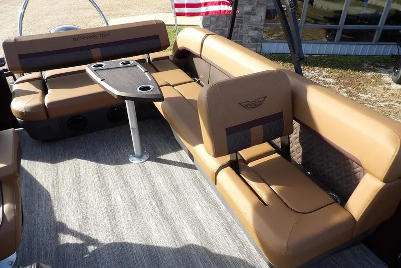Slide: The Image of 2026 Bennington M L-Bench 22 ML boat interior with tan seating and table. - 26
