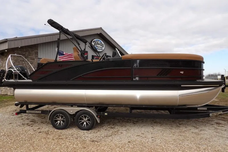 Slide: The Image of 2026 Bennington M L-Bench 22 ML pontoon boat on trailer, parked outdoors. - 3