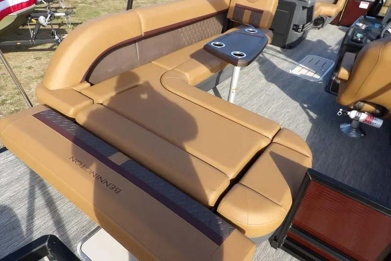 Slide: The Image of 2026 Bennington M L-Bench 22 ML boat interior with tan seating and cup holders. - 33