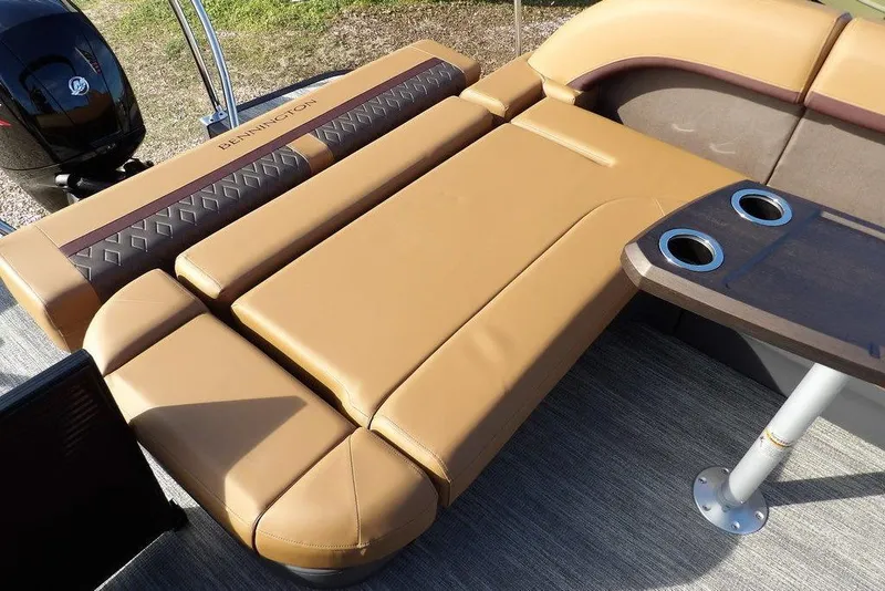 Slide: The Image of 2026 Bennington M L-Bench 22 ML boat interior with tan seating and cup holders. - 37