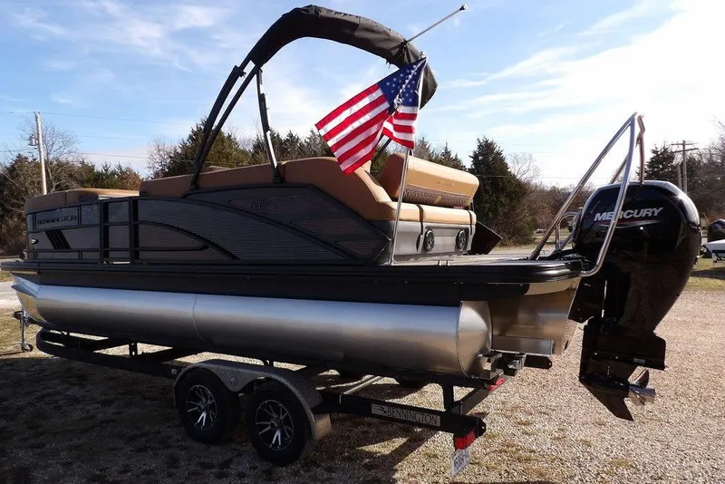 Slide: The Image of 2026 Bennington M L-Bench 22 ML pontoon boat with American flag and Mercury engine. - 5