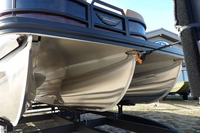 Slide: The Image of 2026 Bennington M L-Bench 22 ML pontoon boat on trailer, showcasing sleek aluminum pontoons. - 51