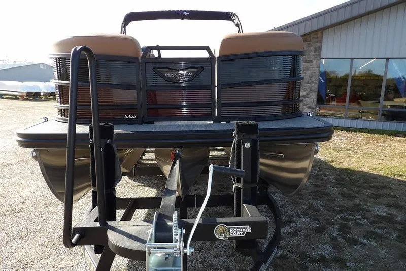 Slide: The Image of 2026 Bennington M L-Bench 22 ML pontoon boat on trailer, front view. - 6