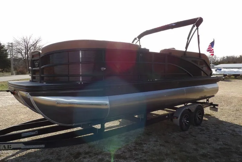 Slide: The Image of 2026 Bennington M L-Bench 22 ML pontoon boat on trailer, parked outdoors. - 8