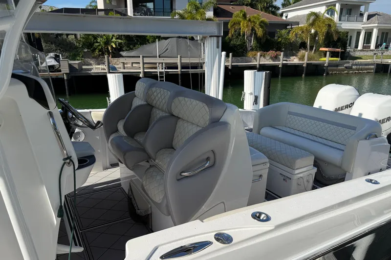 Slide: The Image of 2014 Nor-Tech 340 Sport Center Console boat with luxurious seating and modern design. - 7