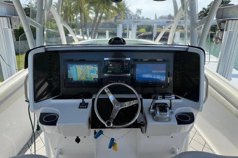 Slide: The Image of 2014 Nor-Tech 340 Sport Center Console helm with advanced navigation displays and controls. - 8