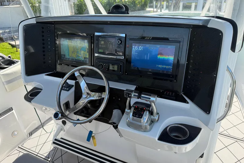 Slide: The Image of 2014 Nor-Tech 340 Sport Center Console dashboard with navigation and control systems. - 9