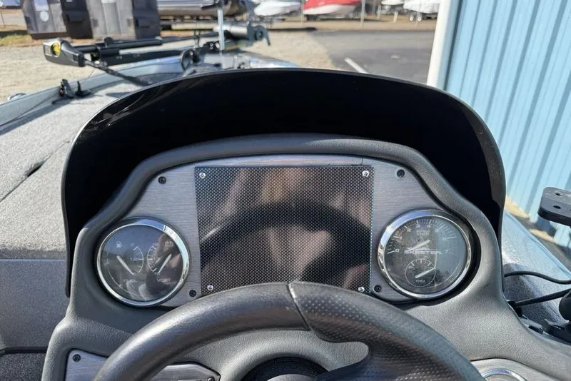 Slide: The Image of 2012 Skeeter TZX190 boat dashboard with gauges and steering wheel. - 13