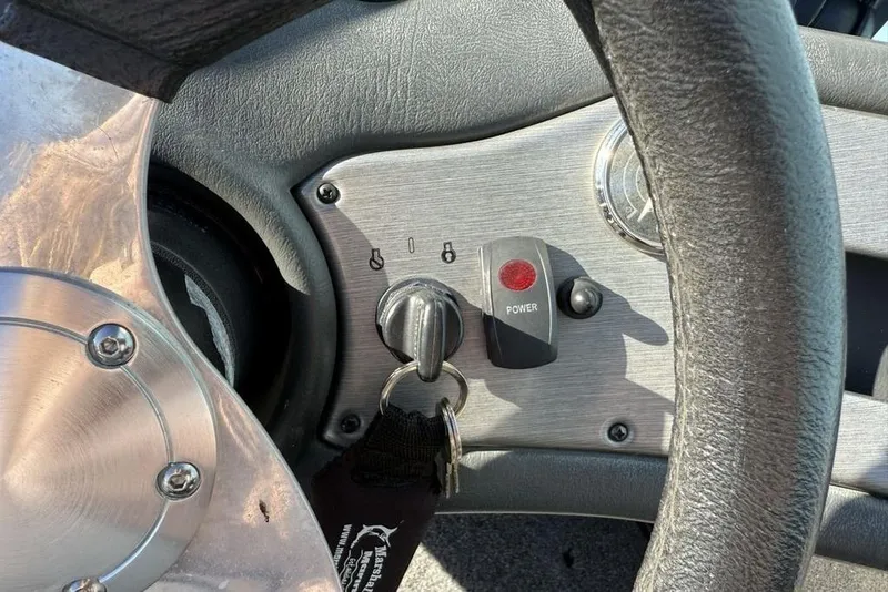 Slide: The Image of Steering wheel and ignition of 2012 Skeeter TZX190 boat with key and power button. - 15