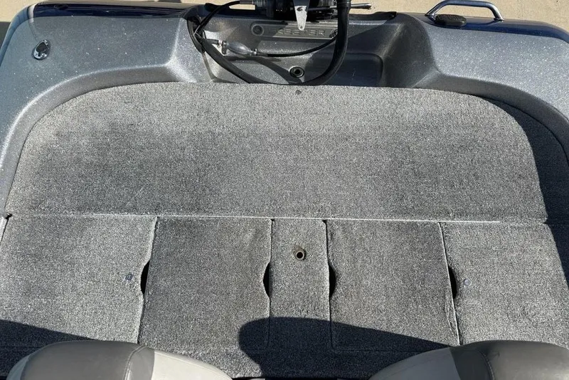 Slide: The Image of 2012 Skeeter TZX190 boat deck with gray carpet and storage compartments. - 20