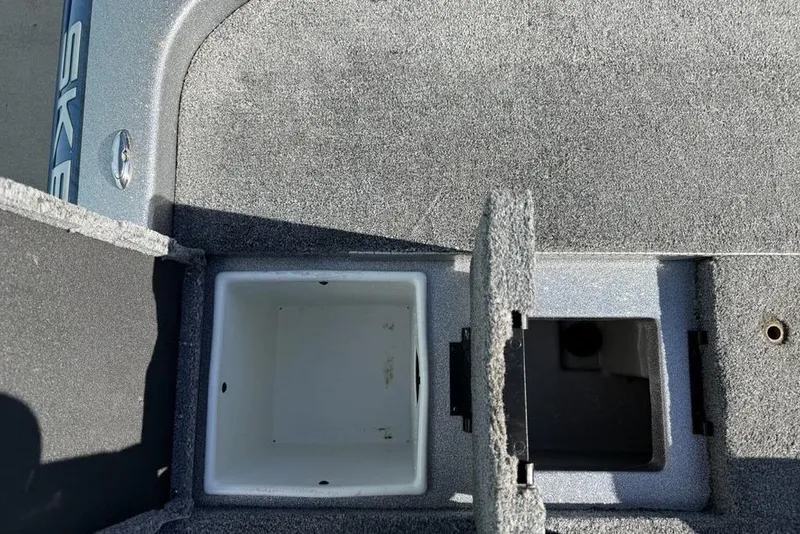 Slide: The Image of 2012 Skeeter TZX190 boat storage compartments with open lids, showcasing interior space. - 23