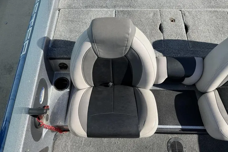 Slide: The Image of 2012 Skeeter TZX190 boat seat with gray and black upholstery, cup holder, and control panel. - 24
