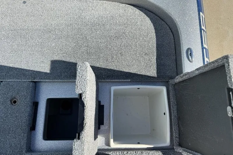 Slide: The Image of 2012 Skeeter TZX190 boat storage compartments with open lids, showcasing interior space. - 25