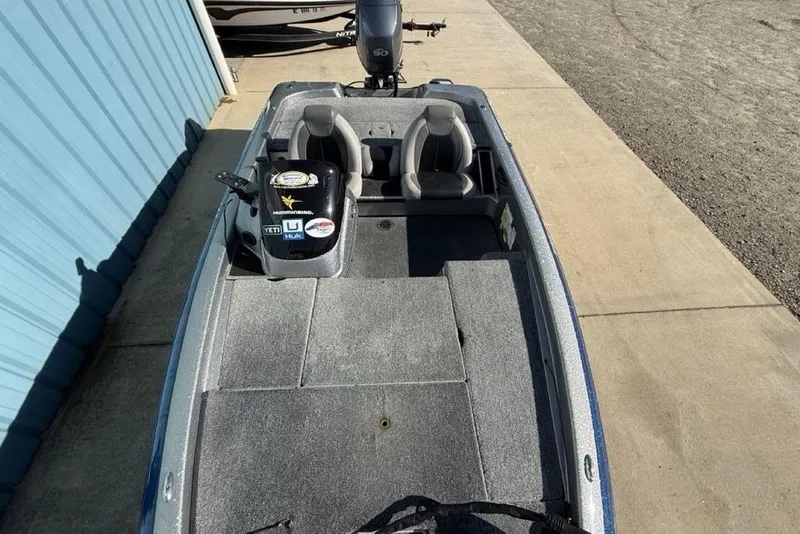 Slide: The Image of 2012 Skeeter TZX190 fishing boat with dual seats and carpeted deck. - 28