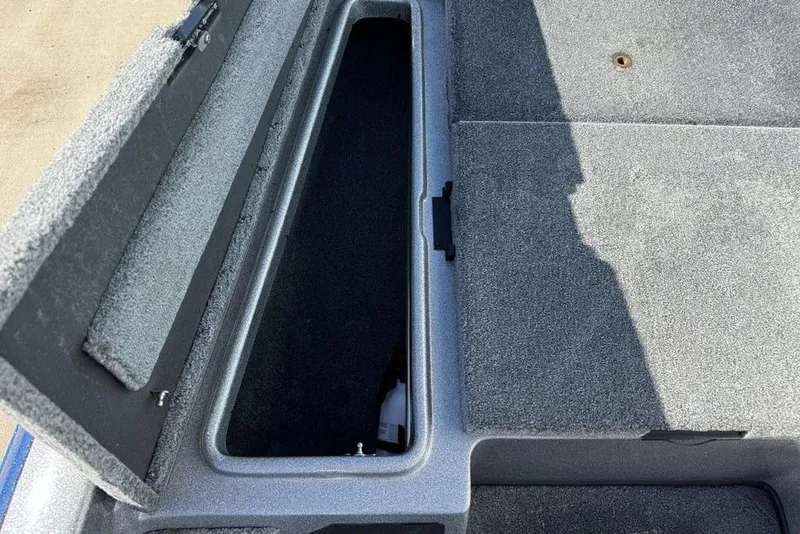 Slide: The Image of Open storage compartment in 2012 Skeeter TZX190 boat, showing interior space. - 8