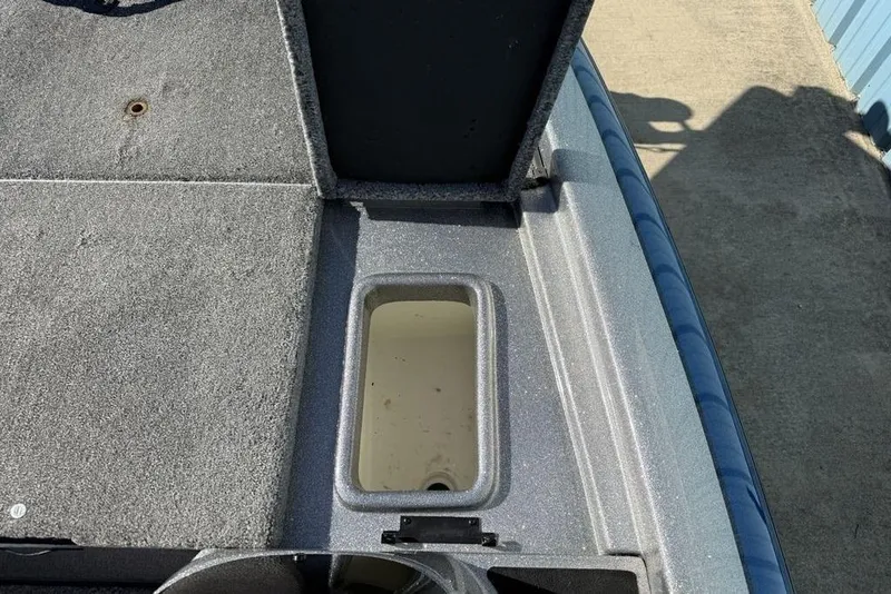 Slide: The Image of 2012 Skeeter TZX190 boat storage compartment with open lid, showing interior details. - 9