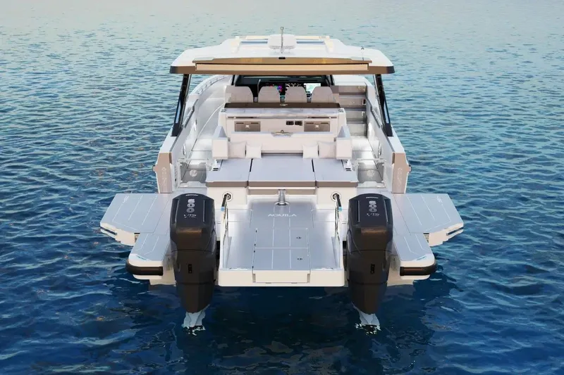Slide: The Image of Aquila 45 Sport 2026 luxury yacht on serene blue water, rear view. - 4