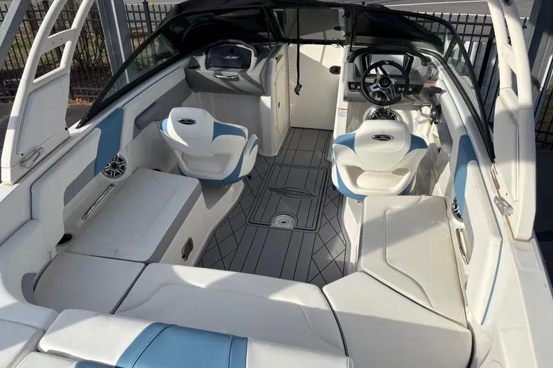 Slide: The Image of 2026 Chaparral GTS 3 boat interior with white and blue seating, modern dashboard, and spacious layout. - 10
