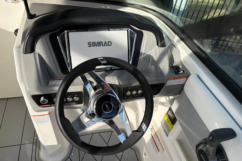 Slide: The Image of 2026 Chaparral GTS 3 boat dashboard with Simrad display and steering wheel. - 5
