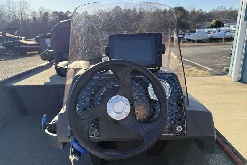 Slide: The Image of 2021 Tracker Bass Tracker Classic XL boat dashboard with steering wheel and navigation display. - 11