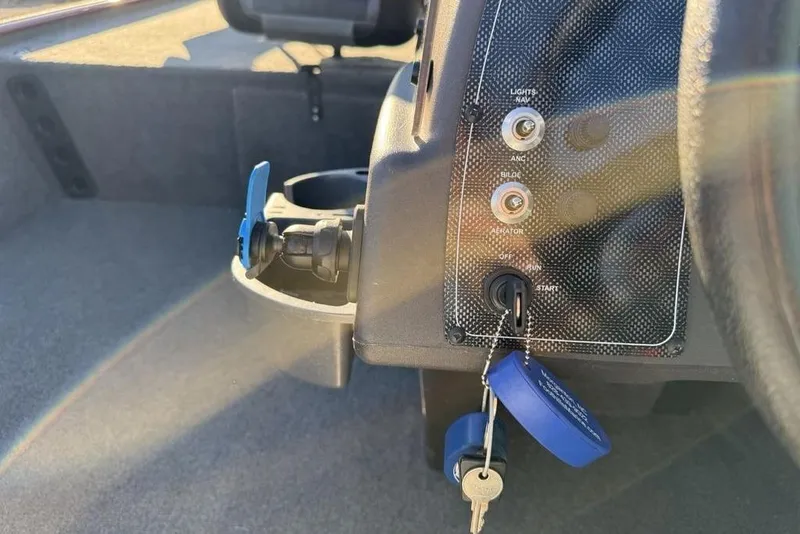 Slide: The Image of 2021 Tracker Bass Tracker Classic XL dashboard with ignition keys and control panel. - 15