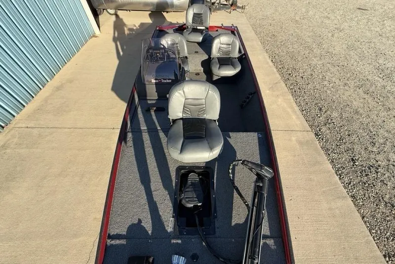 Slide: The Image of 2021 Tracker Bass Tracker Classic XL boat with gray seating and fishing equipment. - 21