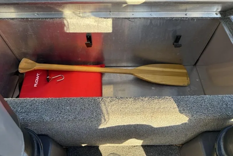 Slide: The Image of Storage compartment in 2021 Tracker Bass Tracker Classic XL with paddle and floatation device. - 25