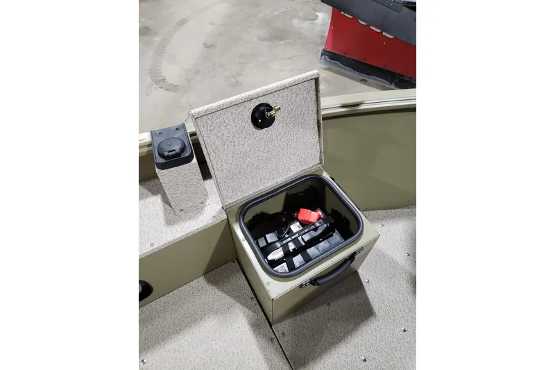 Slide: The Image of 2024 Lund 1675 Alaskan Tiller boat storage compartment with battery inside. - 12