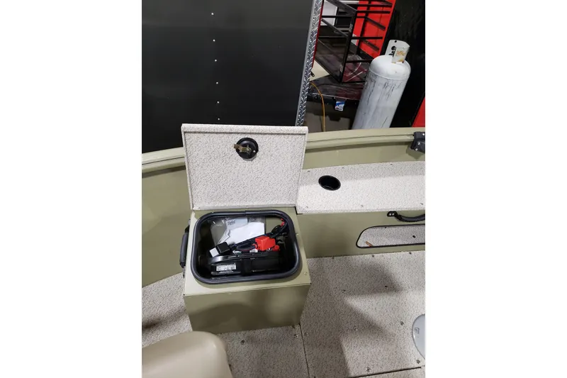 Slide: The Image of 2024 Lund 1675 Alaskan Tiller boat interior with storage compartment open. - 13