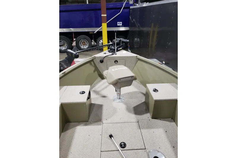 Slide: The Image of 2024 Lund 1675 Alaskan Tiller boat interior with seating and storage compartments. - 16