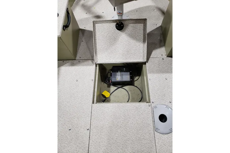 Slide: The Image of 2024 Lund 1675 Alaskan Tiller boat interior with open storage compartment. - 17