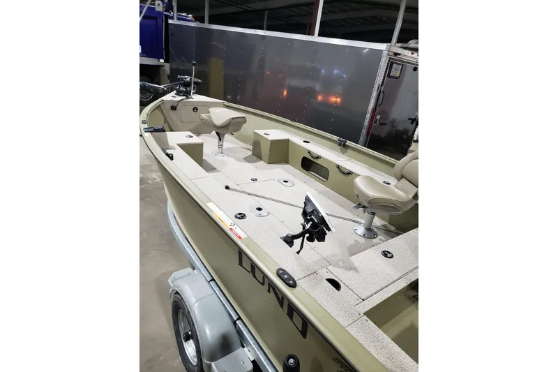 Slide: The Image of 2024 Lund 1675 Alaskan Tiller boat interior with seating and equipment. - 4