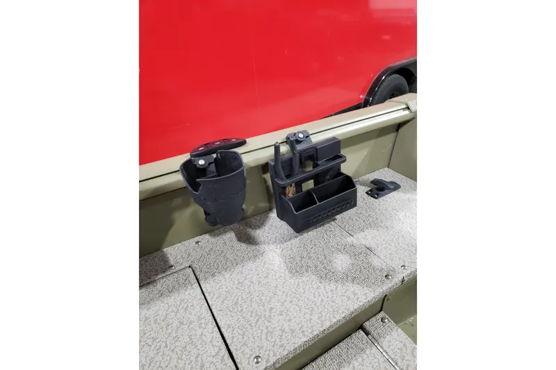 Slide: The Image of 2024 Lund 1675 Alaskan Tiller boat interior with storage compartments and cup holders. - 6